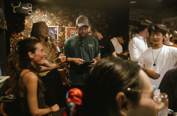 Guests networking at a Doge culture night meetup in Japan